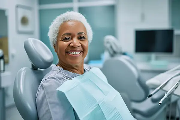 Senior woman smiling in a dental chair during an appointment